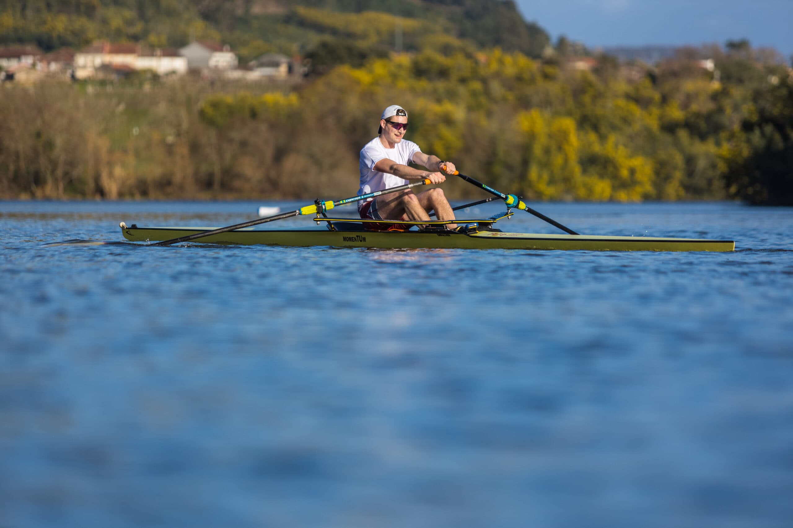 Single sculler on blue water