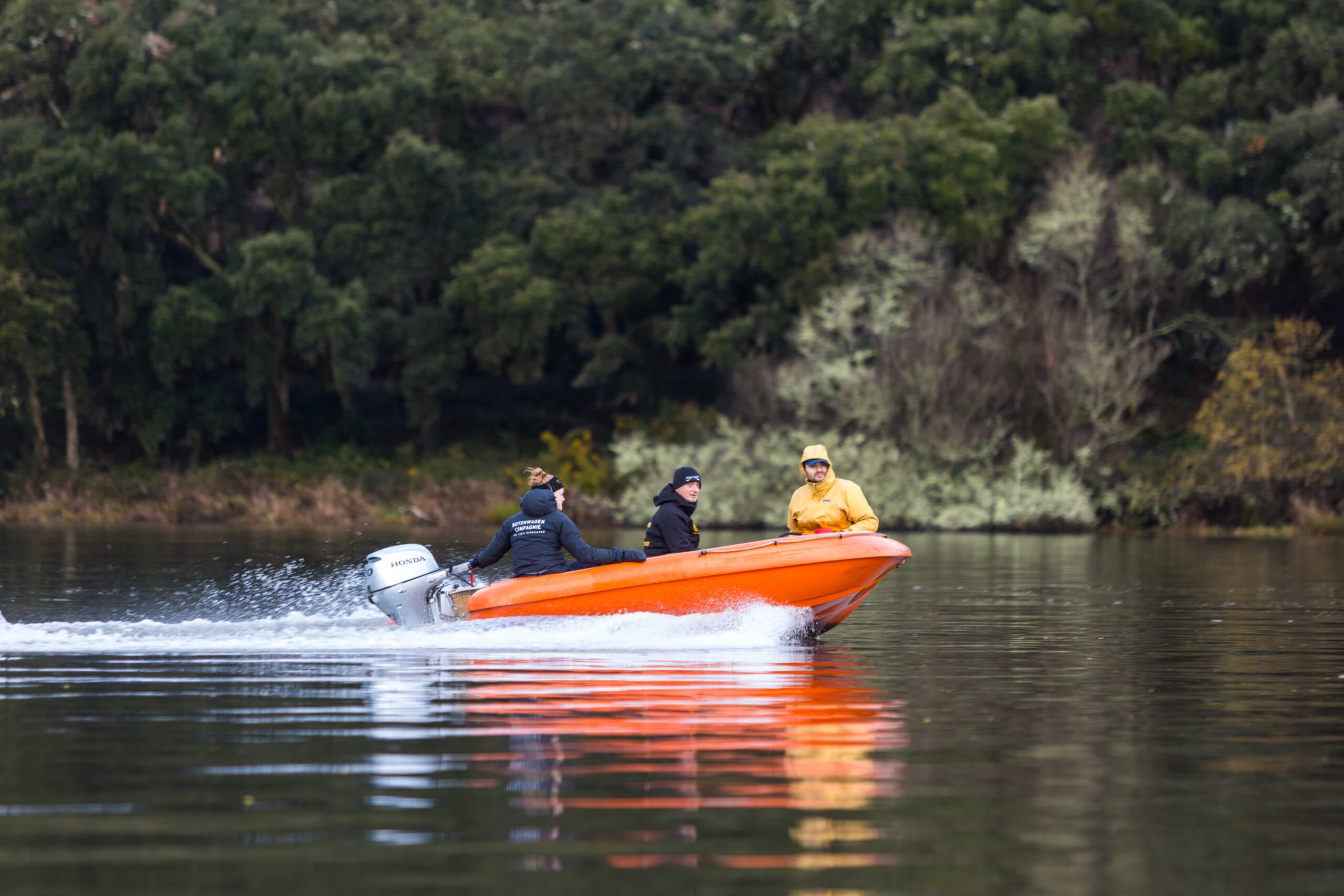Club crew and coaching boat on the river